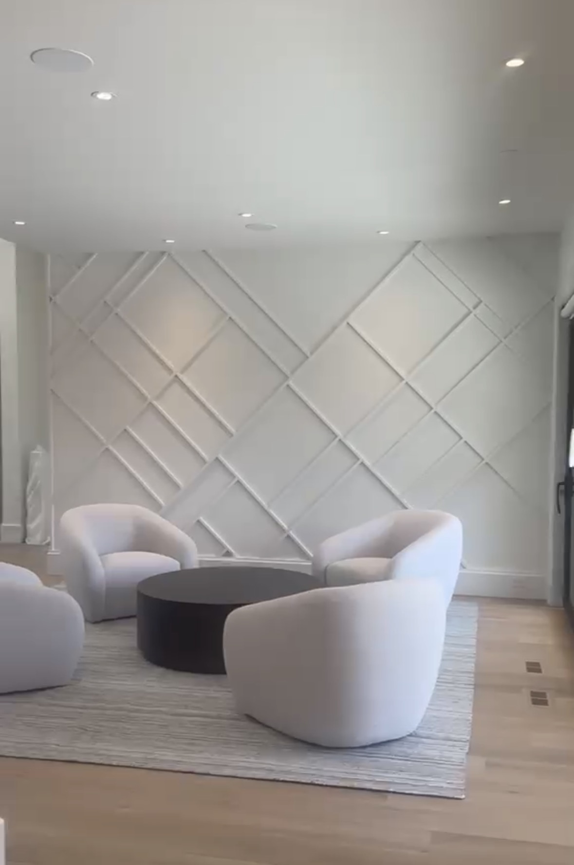 Finished living room with a painted panelled feature wall in a Lower Mainland home